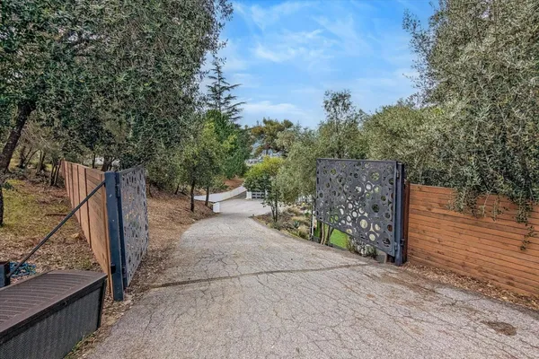 a view of a pathway of a wooden fence