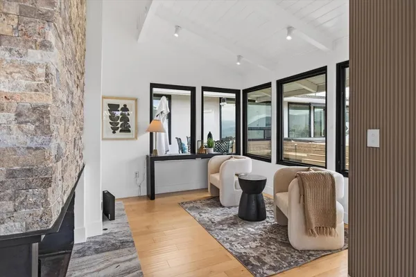 a view of a workspace with furniture and a window