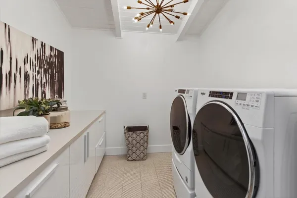a kitchen with white cabinets and a refrigerator