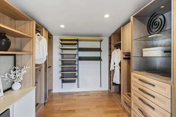 a view of a patio with table and chairs potted plants and large tree