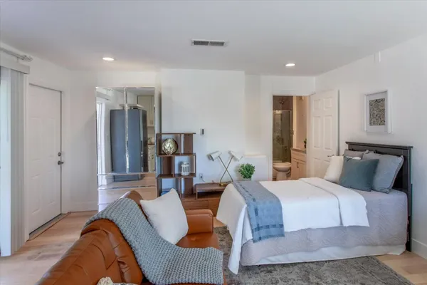a view of a patio with table and chairs potted plants with wooden floor and fence