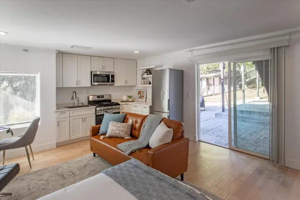 a view of a house with swimming pool and sitting area