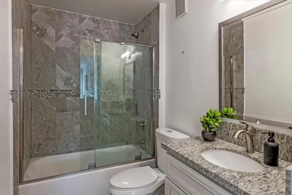 a view of a house with a cars park side of the road