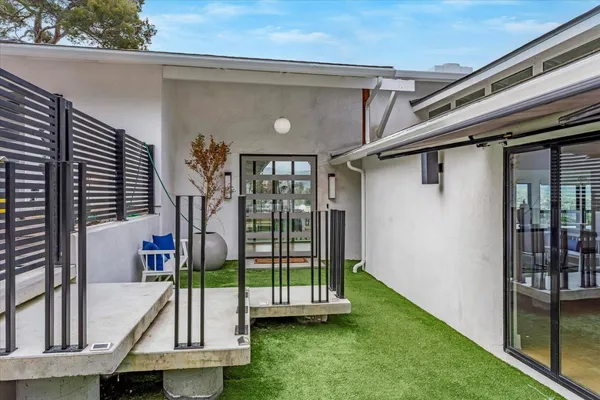 a view of a backyard with furniture and garden