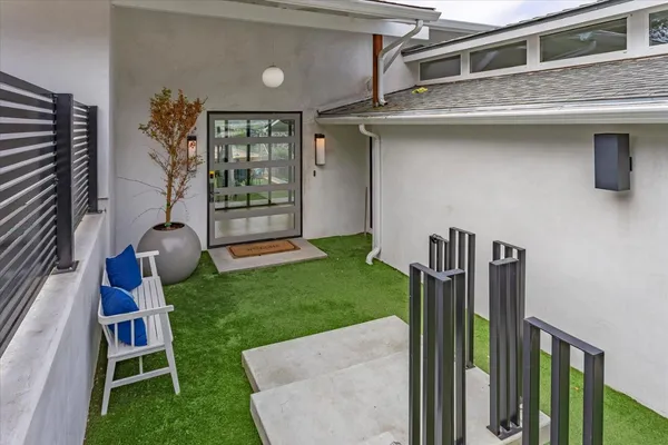 a view of a backyard with table and chairs with an umbrella