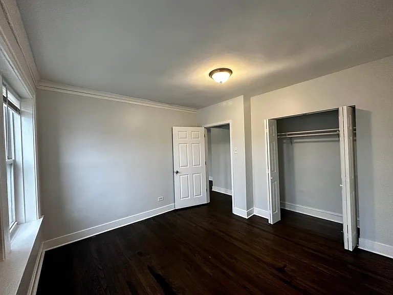 4150 West Belden Avenue, Unit 2 Chicago, IL 60639 - Photo 2 of 9 an empty room with wooden floor and windows