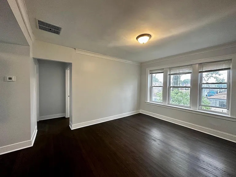 4150 West Belden Avenue, Unit 2 Chicago, IL 60639 - Photo 3 of 9 a view of an empty room with wooden floor and a window