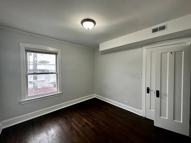 4150 West Belden Avenue, Unit 2 Chicago, IL 60639 - Photo 6 of 9 an empty room with wooden floor and windows