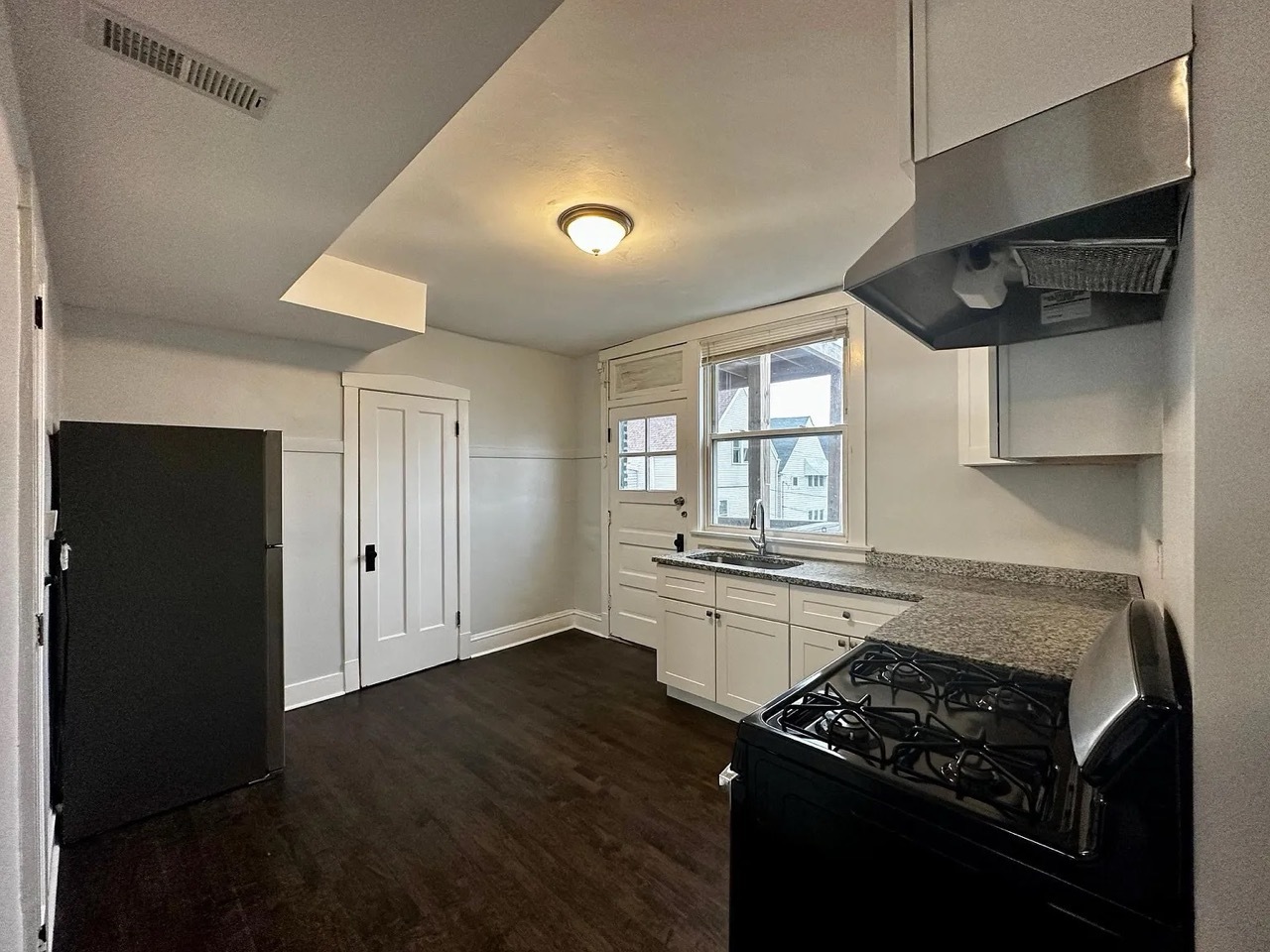 4150 West Belden Avenue, Unit 2 Chicago, IL 60639 - Photo 9 of 9 a kitchen with stainless steel appliances granite countertop a stove a sink and a refrigerator