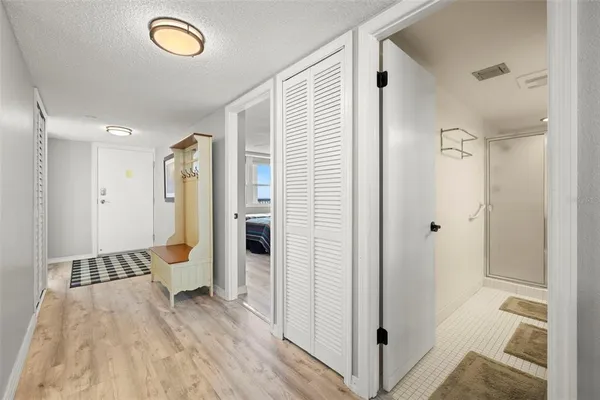 a view of a hallway with furniture and wooden floor