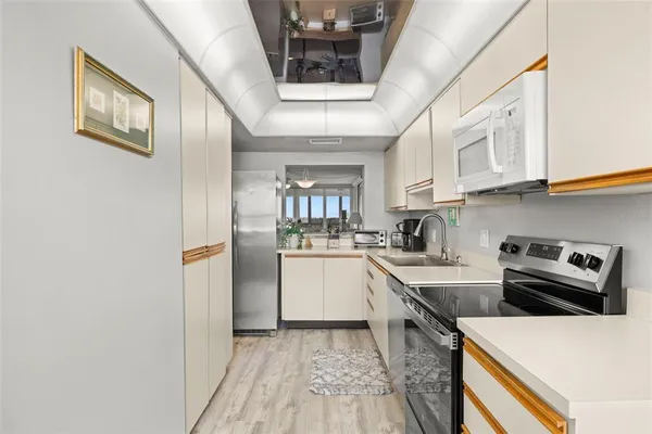 a kitchen with a refrigerator and sink
