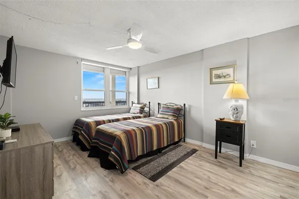a bedroom with two beds and a chandelier