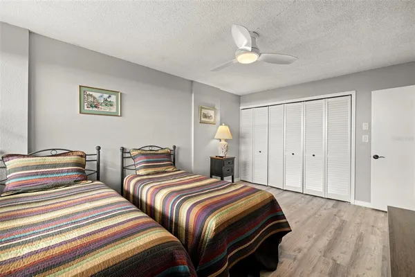 a bedroom with two beds and a large window