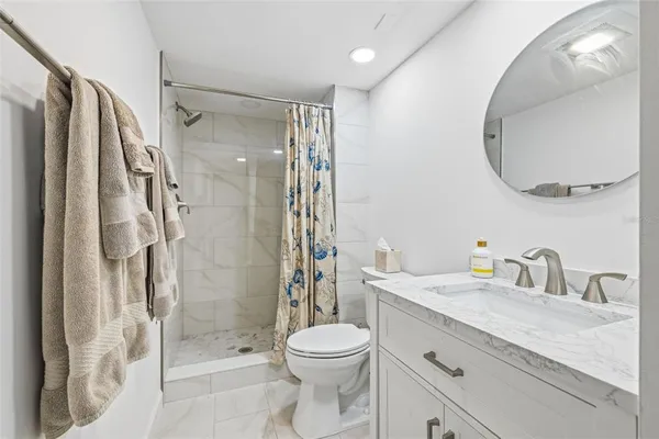 a bathroom with a shower and a glass door