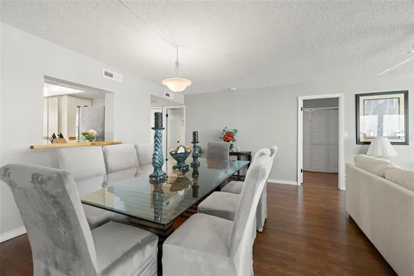 a view of a dining room with furniture and wooden floor
