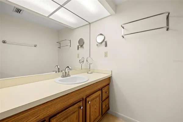 a bathroom with a sink toilet a mirror and shower