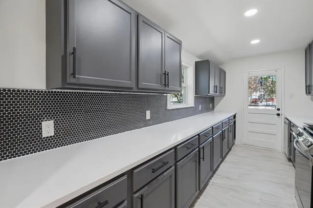 a kitchen with stainless steel appliances granite countertop a sink and dishwasher a stove top oven with wooden floor