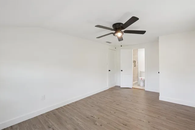 a view of a ceiling fan and hardwood floor