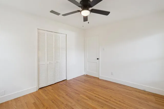 a bathroom with a granite countertop sink a toilet and a bathtub