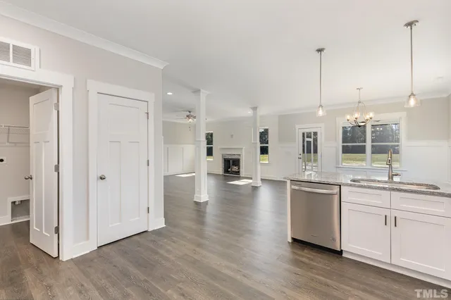 a large kitchen with cabinets and wooden floor