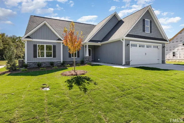 a view of a house with pool and yard