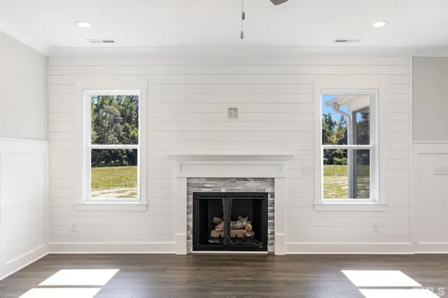a living room with window and a fireplace
