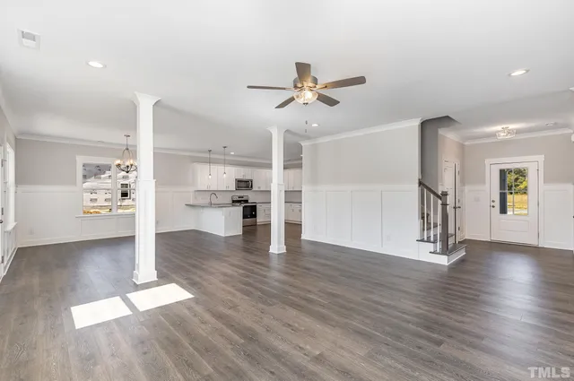 a view of a kitchen with wooden floor and a kitchen