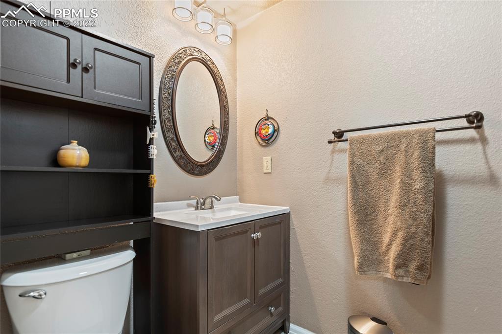 905 Prairie Road Colorado Springs, CO 80909 - Photo 13 of 21 a bathroom with a sink and a mirror