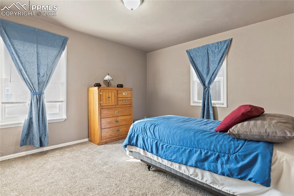 905 Prairie Road Colorado Springs, CO 80909 - Photo 8 of 21 a bedroom with a bed and a window