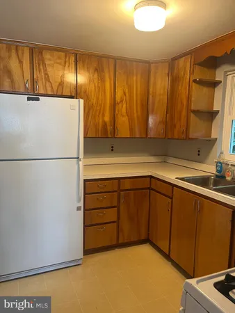a kitchen with a refrigerator and cabinets