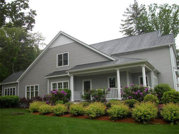 a front view of house with a garden