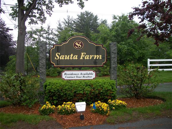 8 Sauta Farm Way, Unit 8 Hudson, MA 01749 - Photo 2 of 30 a sign broad on the side of the road