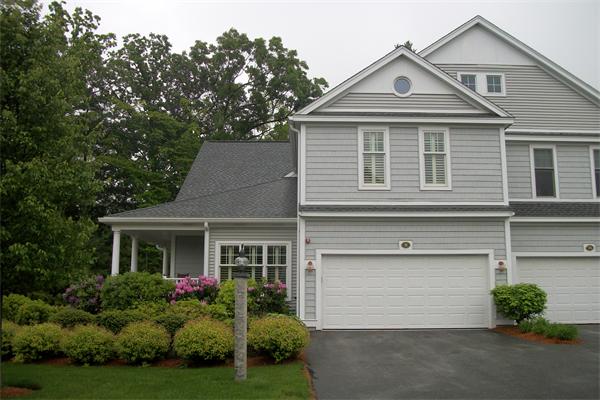 8 Sauta Farm Way, Unit 8 Hudson, MA 01749 - Photo 29 of 30 a front view of a house with a yard and garage