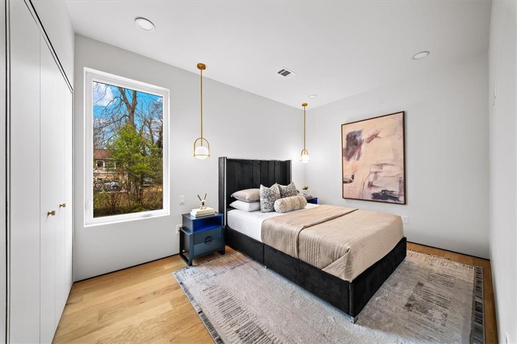 172 Racine Street Southwest Atlanta, GA 30314 - Photo 15 of 32 a bedroom with a large bed and a window