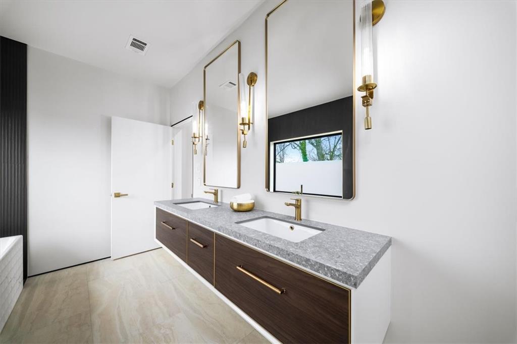172 Racine Street Southwest Atlanta, GA 30314 - Photo 19 of 32 a bathroom with a granite countertop sink and a mirror