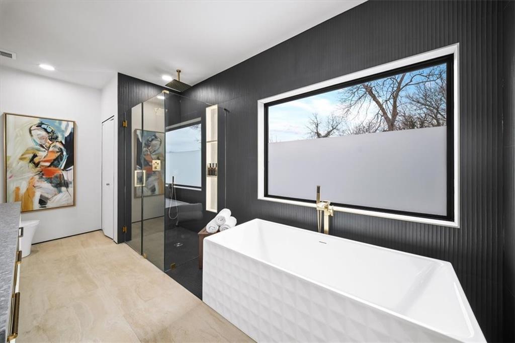 172 Racine Street Southwest Atlanta, GA 30314 - Photo 21 of 32 a bedroom with a large bed and a painting on the wall