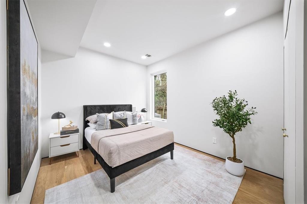 172 Racine Street Southwest Atlanta, GA 30314 - Photo 23 of 32 a bedroom with a bed plant and a potted plant