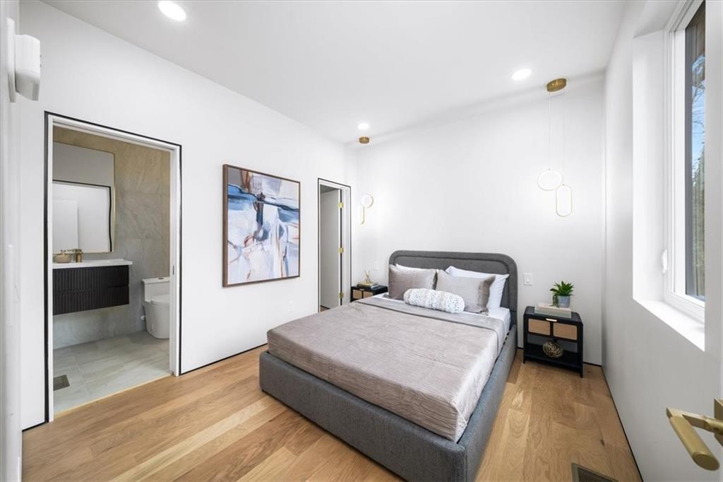 172 Racine Street Southwest Atlanta, GA 30314 - Photo 29 of 32 a bedroom with a bed and a painting on the wall