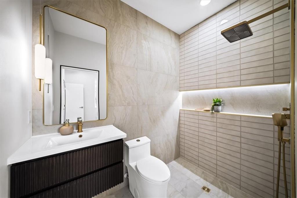 172 Racine Street Southwest Atlanta, GA 30314 - Photo 30 of 32 a bathroom with a sink a toilet and shower