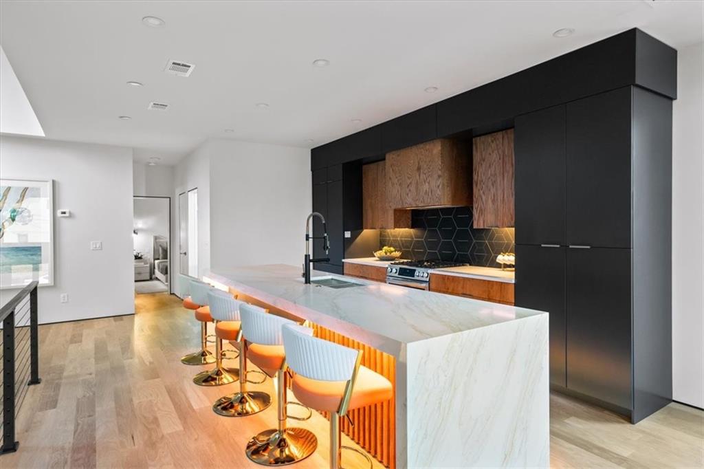 172 Racine Street Southwest Atlanta, GA 30314 - Photo 10 of 32 a large kitchen with stainless steel appliances a large counter top a stove and a refrigerator