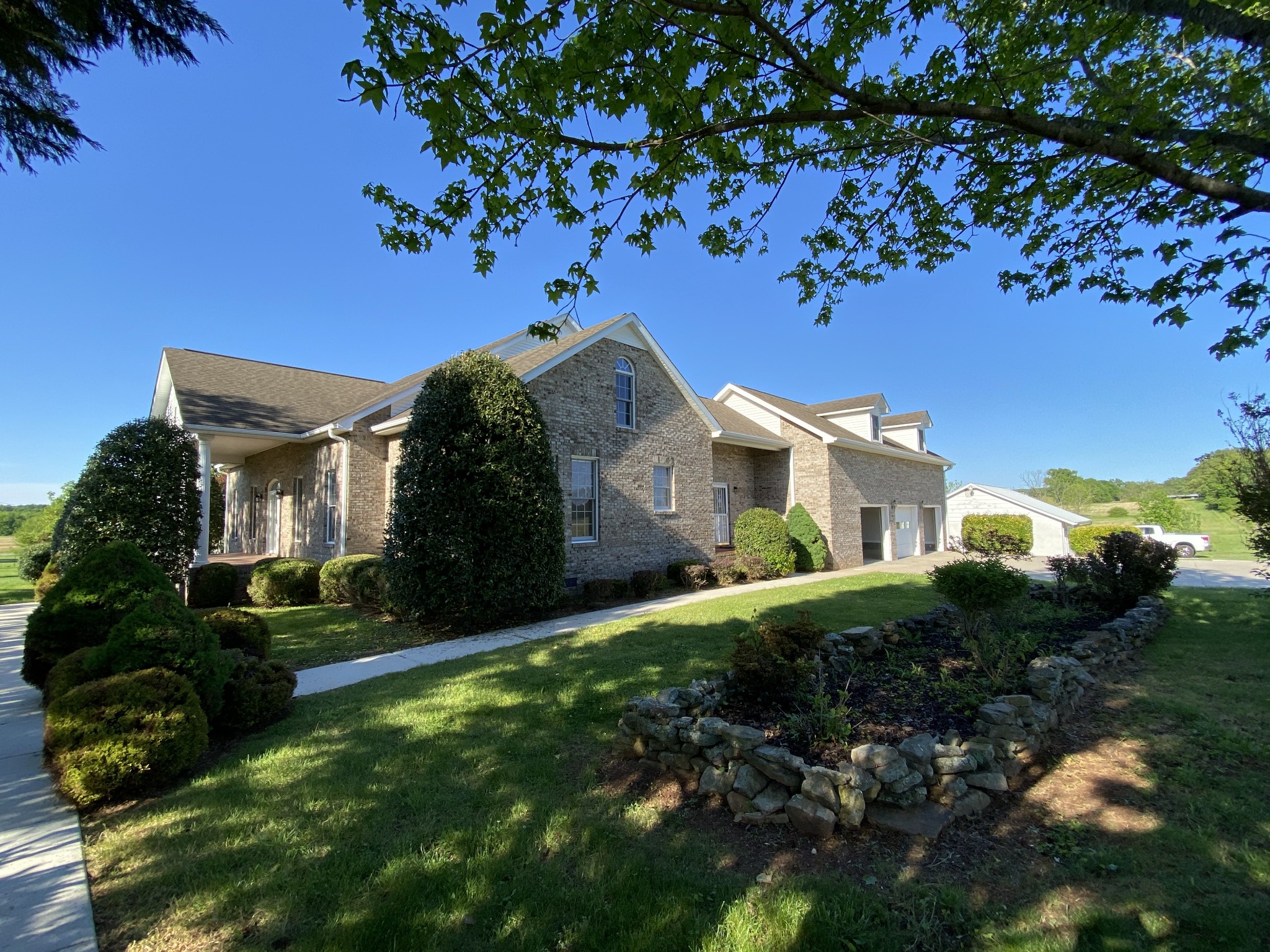 1370 Shelly Road Decherd, TN 37324 - Photo 17 of 44 a front view of a house with a garden