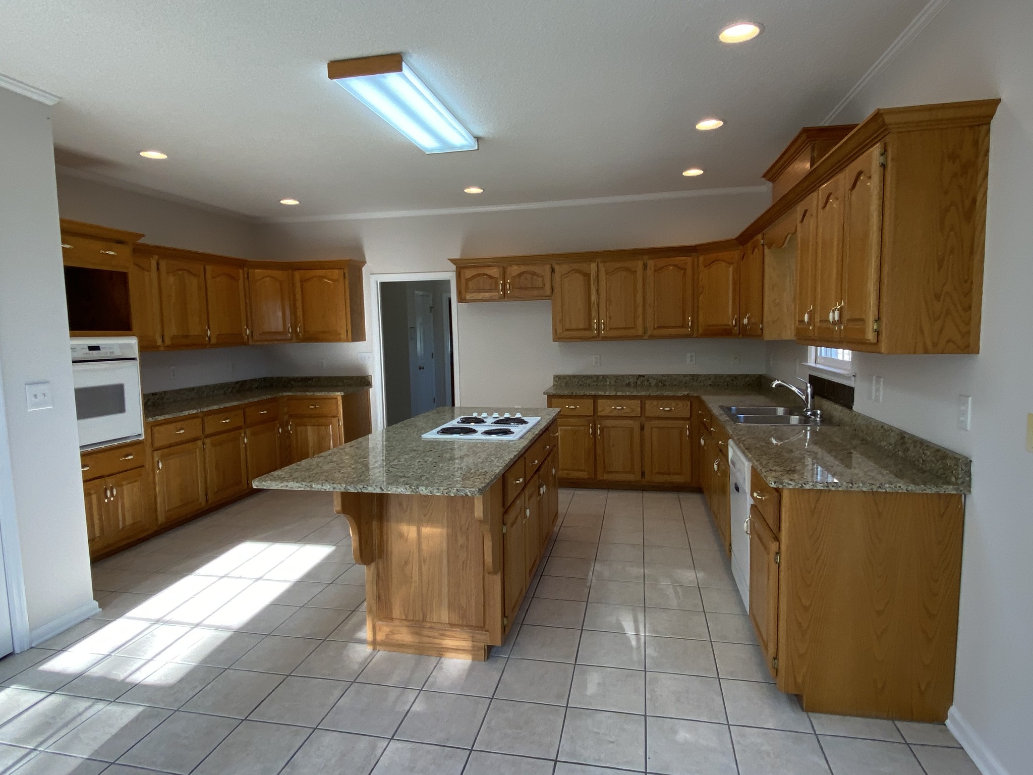 1370 Shelly Road Decherd, TN 37324 - Photo 27 of 44 a kitchen with stainless steel appliances granite countertop a stove a sink and a refrigerator
