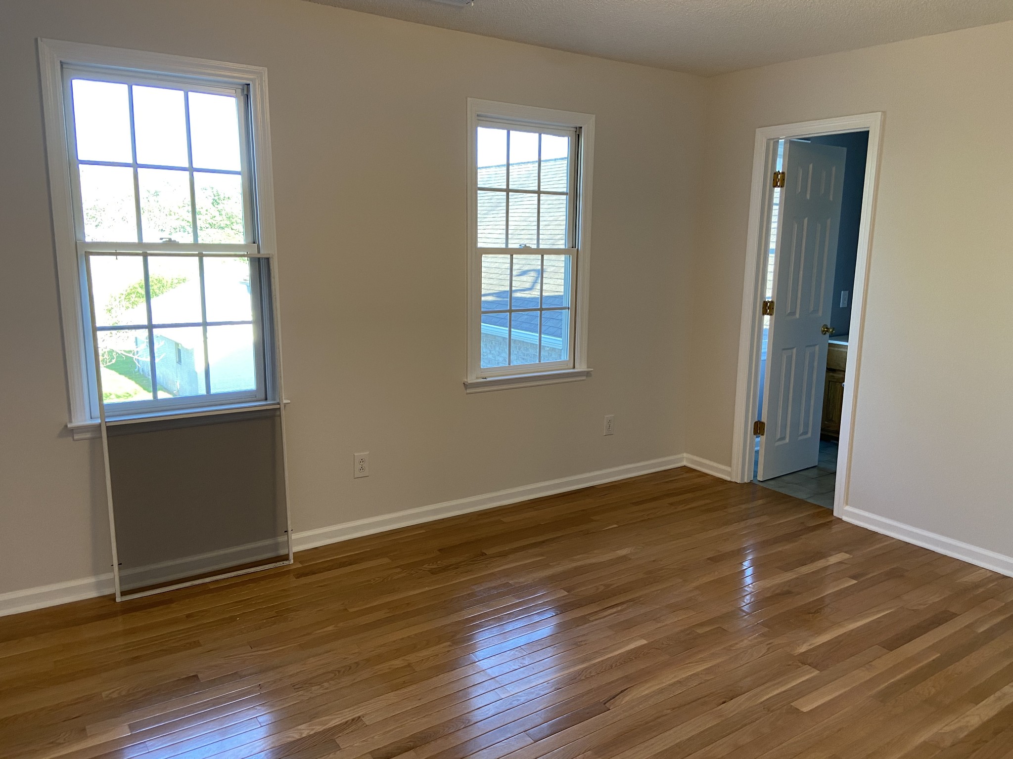 1370 Shelly Road Decherd, TN 37324 - Photo 37 of 44 an empty room with wooden floor and windows