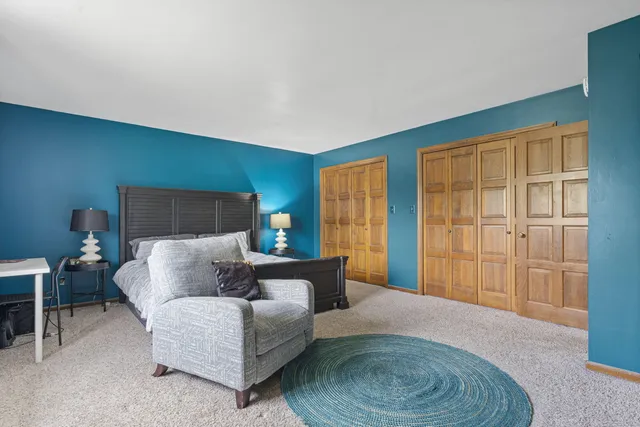 a bedroom with a bed and a mirror