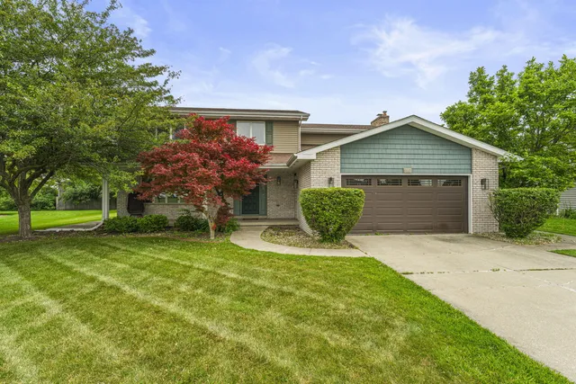 a view of an house with backyard space and garden