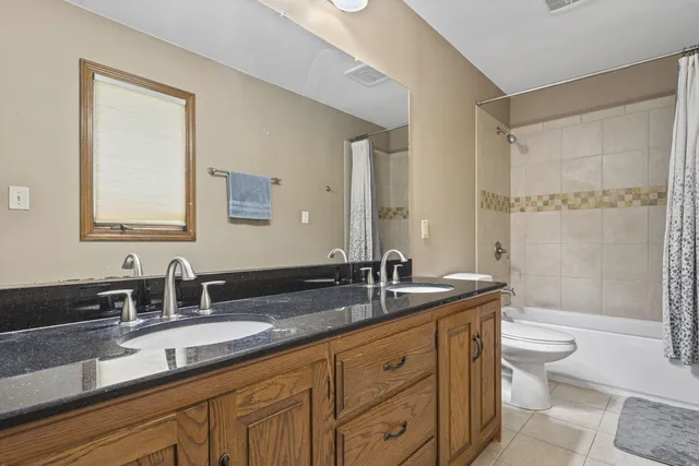 a bathroom with a double vanity sink and a mirror
