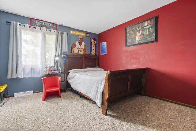 a living room with furniture a window and a flat screen tv