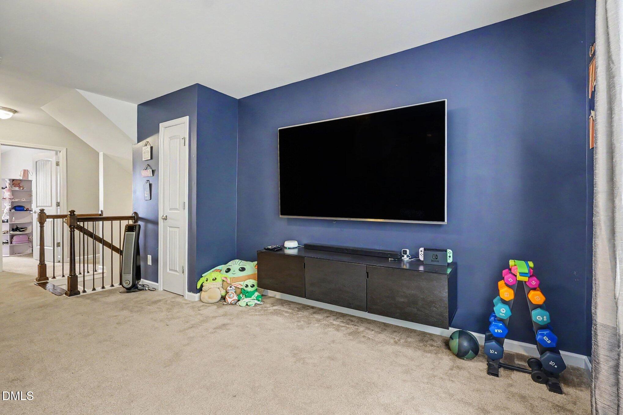 4366 Auburn Hills Drive Raleigh, NC 27616 - Photo 20 of 40 a living room with furniture and a flat screen tv