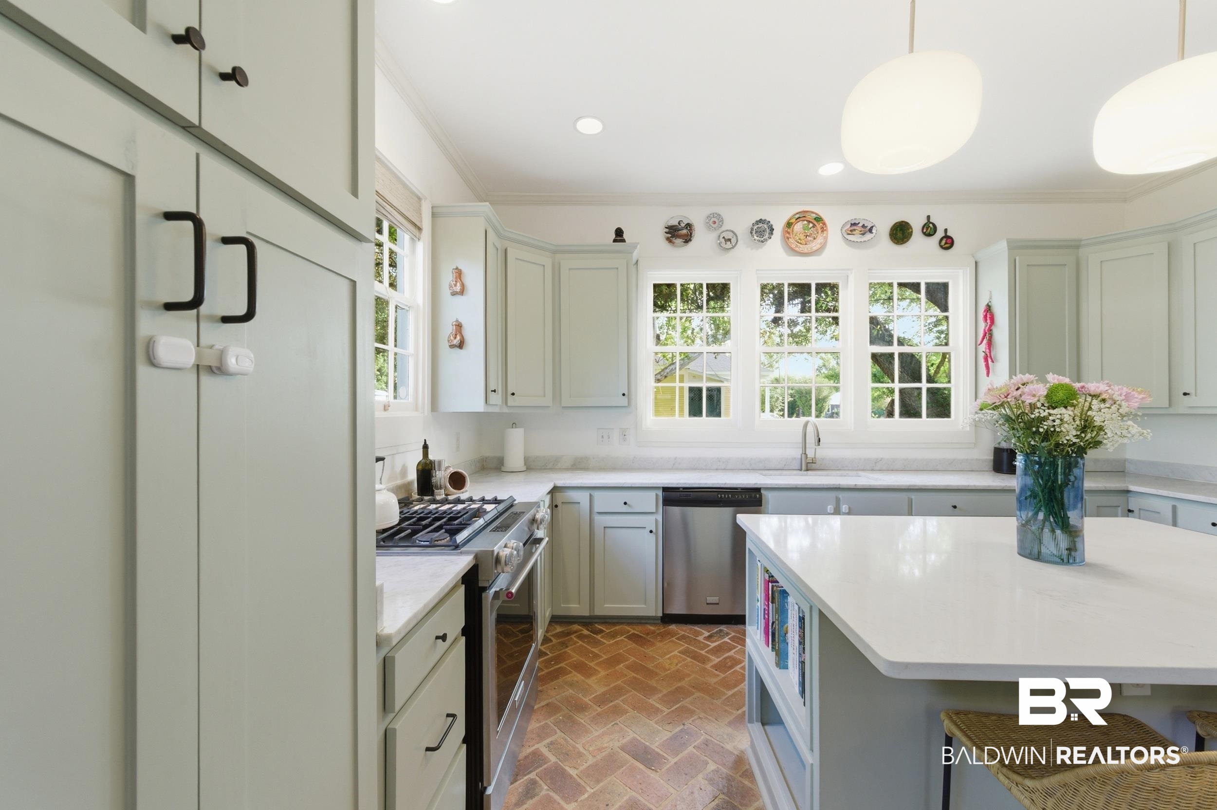 350 Charles Street Mobile, AL 36604 - Photo 11 of 52 Kitchen featuring light-toned cabinetry, white countertops, and herringbone brick flooring