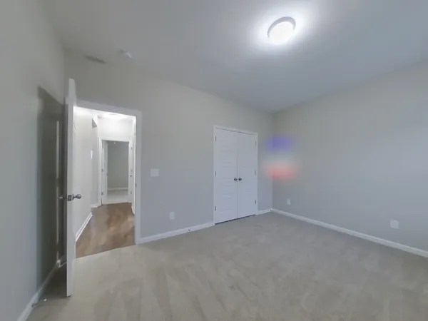 a view of an empty room and closet